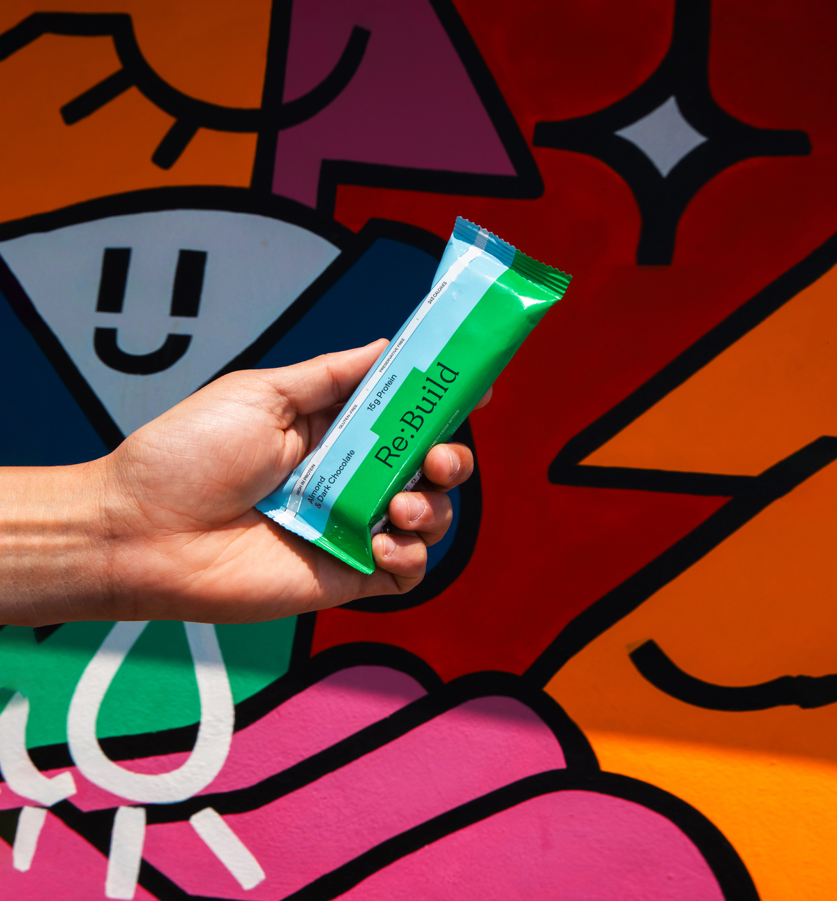A green and blue box containing 12 protein bars. The name Re:Build is displayed on the box.